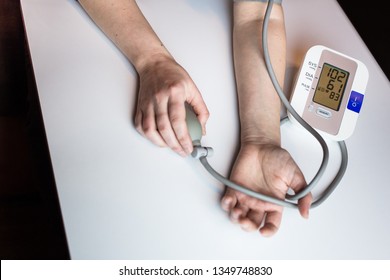 Woman Measuring Her Blood Pressure. Pulse Measuring Device Showing Low Blood Pressure Reading. Hypotension. Heart Health, Healthcare And Medical Concept, Self-care