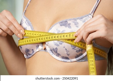 Woman Measuring Her Bra Size With Tape Measure