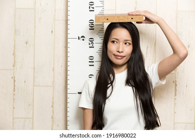 A Woman Measuring Her Height.