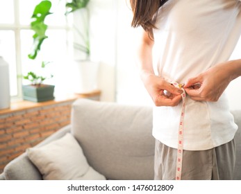 Woman Are Measuring Tape Around Her Waist With Copy Space. For Diet, Heath, Reducing Excess Weight, Woman's Concerns, Lifestyle Concept