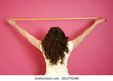 Woman with a measuring tape. Conceptual image shot