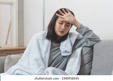 Woman measuring temperature her body on the bed. person got fever lying on the bed. - Shutterstock ID 1340958545