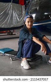 Woman Mechanic Resting After The Modernization Aircraft In Hangar