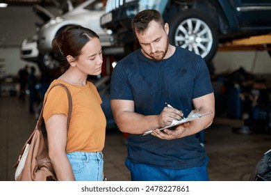 Woman, mechanic and sign paperwork in auto repair shop, invoice and service for car maintenance bill. Female person, clipboard and customer for vehicle transaction, contract and garage workshop - Powered by Shutterstock