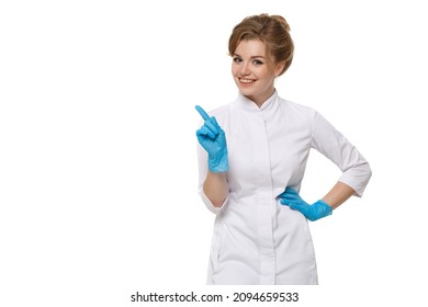 Woman medic in white coat and blue gloves shows gesture of shaking her finger isolated on white background.