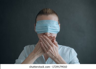 woman with medical face mask, dressed in eyes. concept of conspiracy, deception and misinformation about the state of affairs with the epidemic of coronavirus and quarantine