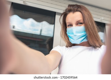 Woman With Medical Face Mask Taking A Selfie. 
