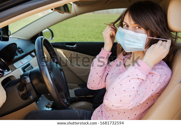 Woman in the medical mask in car.\
coronavirus, disease, infection, quarantine,\
covid-19