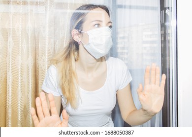 Woman with medical mask stay at home on quarantine closeup. - Shutterstock ID 1688050387