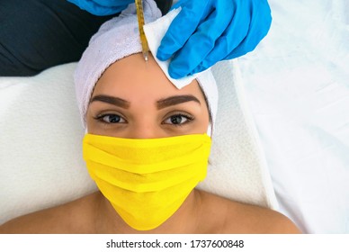 Woman With Medical Mask Who Gets A Botox Injection In Her Face, Up Close