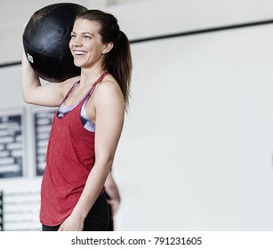 Woman With Medicine Ball On Shoulder