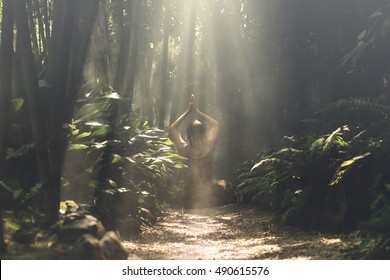 Woman Meditating In A Bamboo Forest