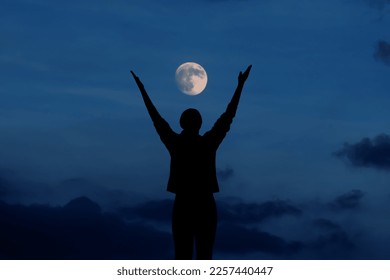 Woman meditating and celebrating under the full moon	 - Powered by Shutterstock