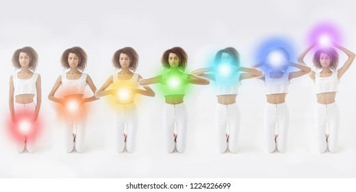 Woman meditating. Colored chakra lights over her body. Yoga, zen, Buddhism, recovery and wellbeing concept.
