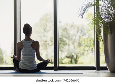 Woman Meditating At Home. Girl Practicing Yoga In Class. Relaxation At Home, Body Care, Balance, Healthy Lifestyle, Meditation, Mindfulness, Recreation, Workout, Fitness, Training, Self Care Concept