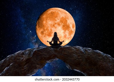 Woman meditating and observing the moon
