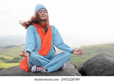Woman Meditating On Mountaintop With Scenic View - Powered by Shutterstock