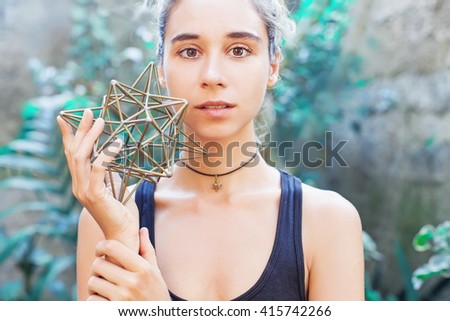 Woman meditating on sacred geometry