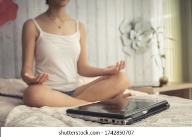 Woman Meditating In Quarantine In Room On Digital Disconnect