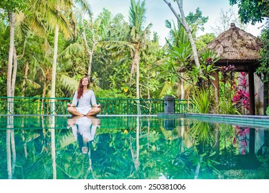 Woman meditation at gorgeous pool side of luxury tropical villa - Powered by Shutterstock