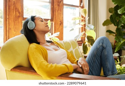 Woman, meditation and headphones, listen to music or podcast for peace and stress relief, sleeping and relax at home. Streaming online, self care and wellness with content female listening to radio - Powered by Shutterstock