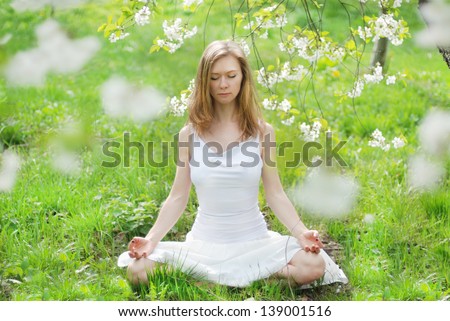 Similar – Young woman doing yoga in nature