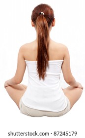 woman in meditation pose taken from behind
