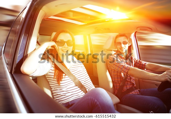 Woman and men in car and\
summer trip 