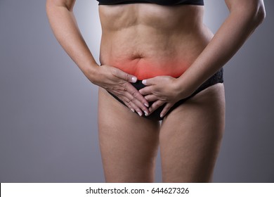 Woman With Menstrual Pain, Endometriosis Or Cystitis, Stomach Ache On Gray Background