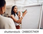 Woman, mentor and whiteboard in office for training, teaching and learning for skill or career development. People, employee and coach or leader at workshop with internship program and motivation