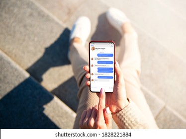 Woman messaging with her friend on phone