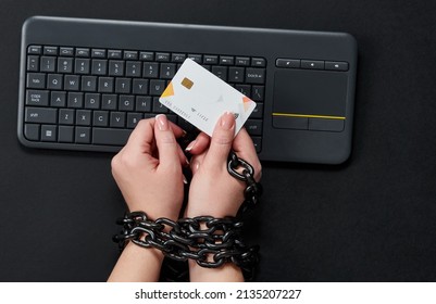 Woman With Metal Chain Holding Credit Card Over Keyboard, Online Shopping Addiction Concept