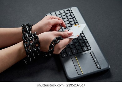 Woman With Metal Chain Holding Credit Card Over Keyboard, Online Shopping Addiction Concept