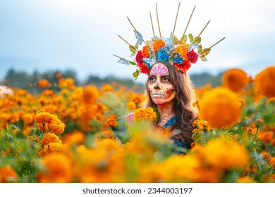 Woman with Mexico Catrina makeup in flower field, serious woman in traditional costume and headwear wearing, standing on field among blooming marigold flowers while looking away. Day of death. - Powered by Shutterstock