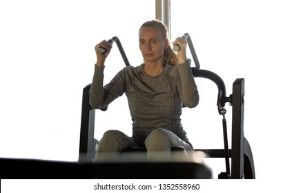 Woman of middle age working out in gym. Healthy lifestyle.Training on exercise machine.