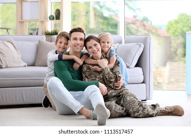 Woman In Military Uniform With Her Family At Home