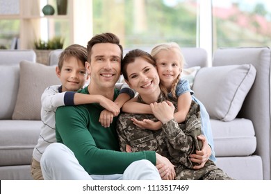 Woman In Military Uniform With Her Family At Home