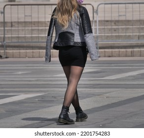  Woman In Miniskirt And Shiny Black Pantyhose In The Square.