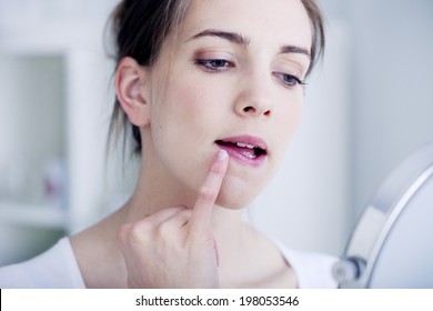 Woman with mirror - Shutterstock ID 198053546