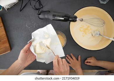 Woman with a mixer beats dough for baking, adding cottage cheese. Top view, flat lay.