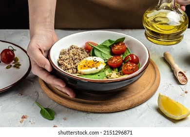 Woman Mixing Delicious Superfood Salad Quinoa, Avocado, Egg, Tomatoes, Spinach And Sunflower Seeds On Light Background. Healthy Food, Ketogenic Diet, Diet Lunch Concept, Place For Text, Top View,