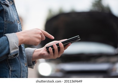 Woman With Mobile Phone On The Broken Car Background. Tow Truck Service. Car Service Call.