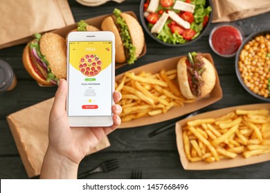 Woman with mobile phone ordering food online - Shutterstock ID 1457668496