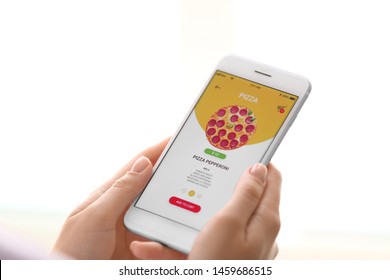 Woman With Mobile Phone Ordering Food Online, Closeup