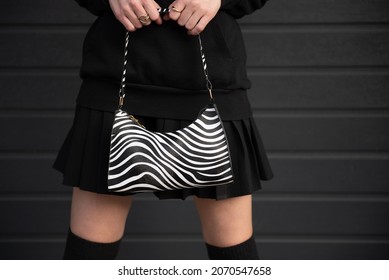 Woman Model No Face In Black Dress And Black Sweatshirt Posing On Black Background Holds Zebra Texture Womans Bag