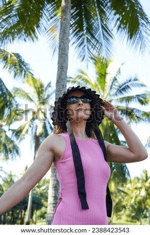 Similar – Brunette surfer woman in bikini standing with surfboard