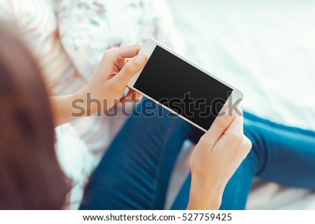 Woman with modern mobile phone in hands 