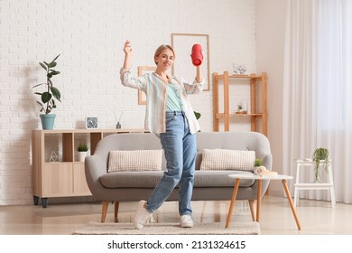 Woman With Modern Wireless Portable Speaker Dancing In Room