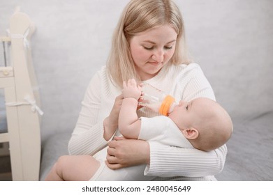 Woman mom holds newborn baby in arms and bottle feeds him, providing comfort and care. - Powered by Shutterstock