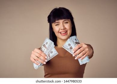 woman with money on beige background                            